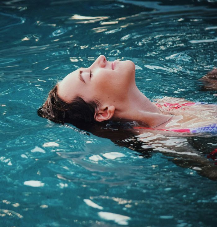 The Sloan at LoSo apartments in Charlotte, NC woman swimming on her back in a refreshing pool